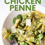 Overhead of a bowl of pasta with a fork loaded with a bite. A text overlay reads, "Pesto Chicken Penne."