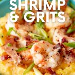 Close up of a teal bowl filled with grits topped with shrimp, bacon, and green onions. A text overlay reads, "10-Minute Shrimp & Grits"