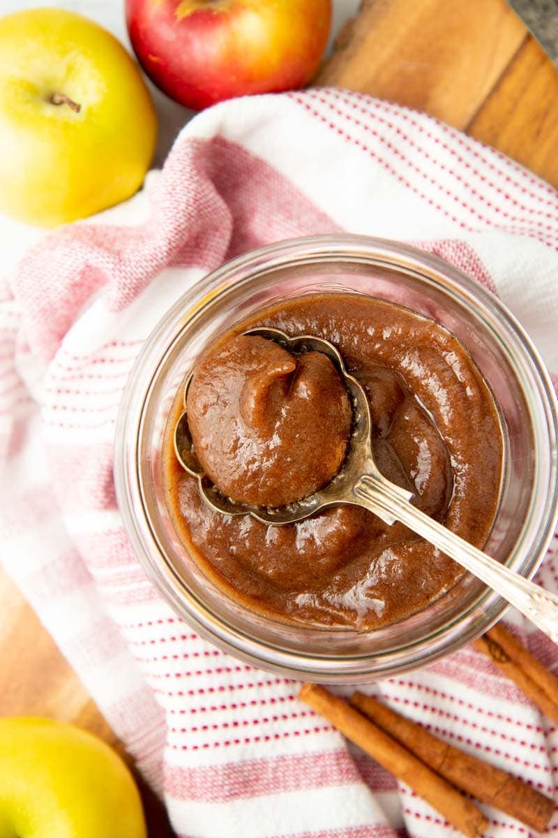 Close-up of a spoonful of apple butter in a jar.