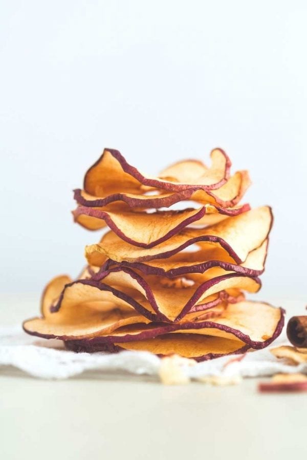 A stack of dried apple slices on a white background.