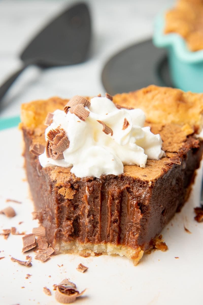 Close view of a slice of chocolate pie with a bite out of it.