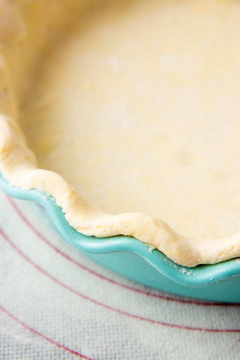 Uncooked gluten-free pie crust in a pie plate close-up.