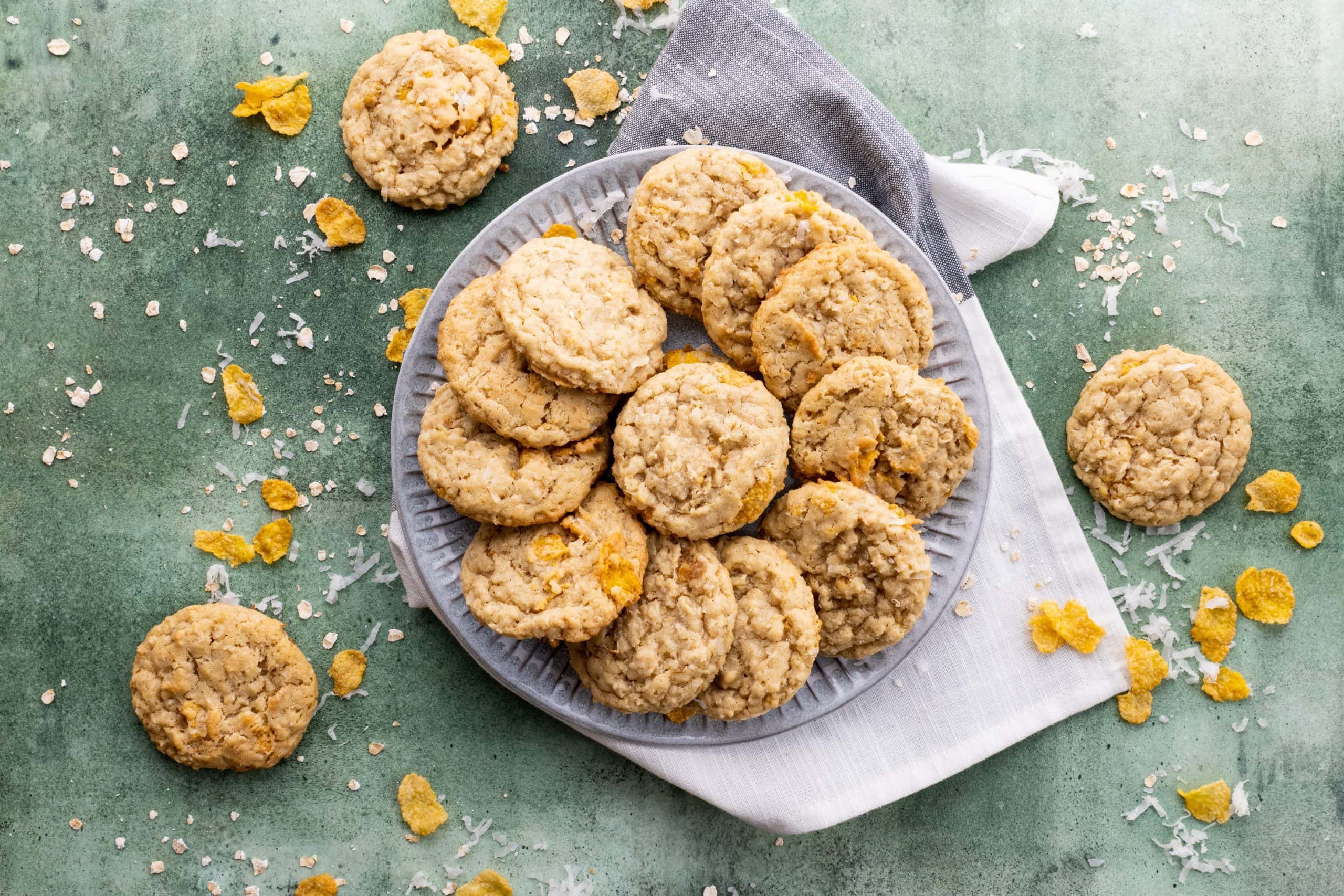 Ranger cookies are arranged in a circle on a grey plate.