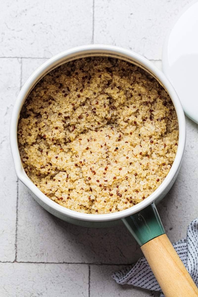 Overhead of prepared quinoa in a pot on a countertop.