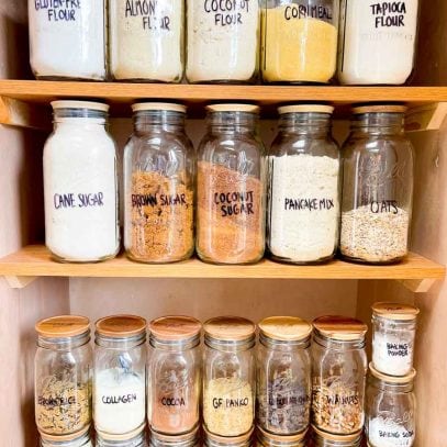 Front view of organized pantry essentials in glass Ball jars with wooden lids.