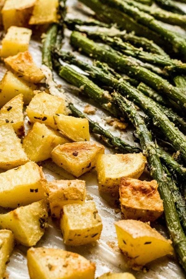Roasted veggies side by side on a sheet pan up close.