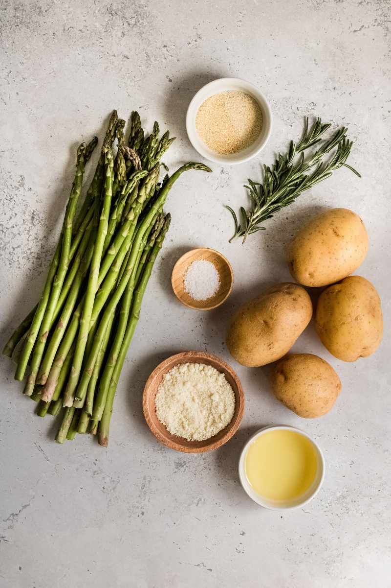 Overhead of ingredients needed to make oven roasted potatoes and asparagus.