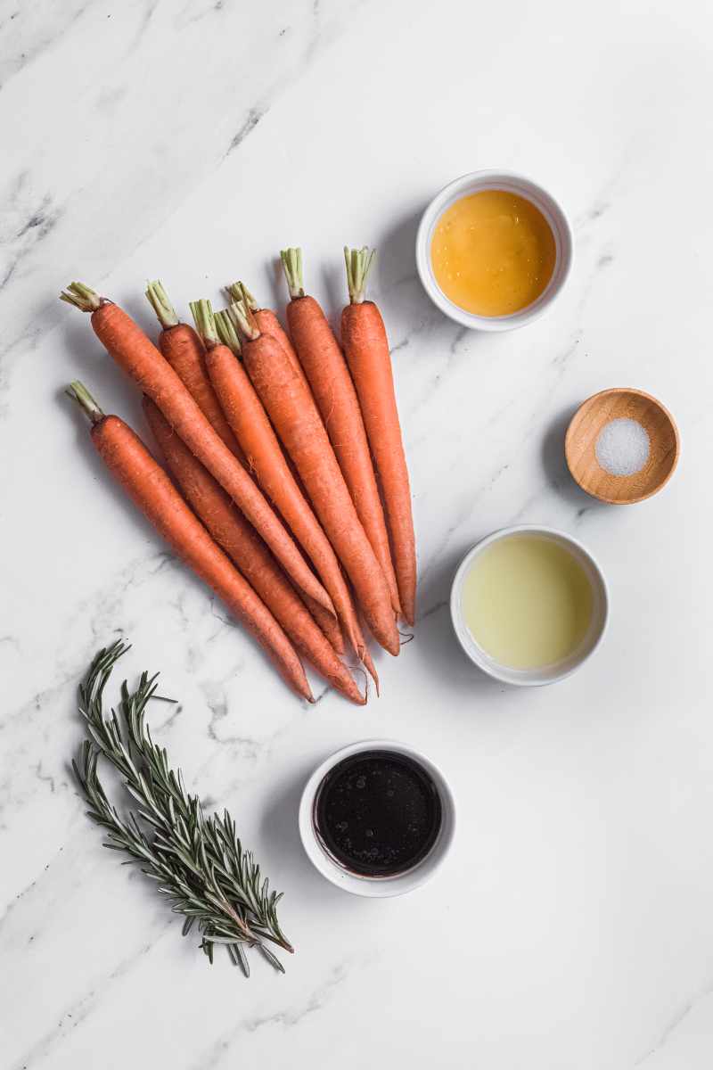 Ingredients needed for this recipe including carrots, oil, balsamic vinegar, and fresh rosemary.