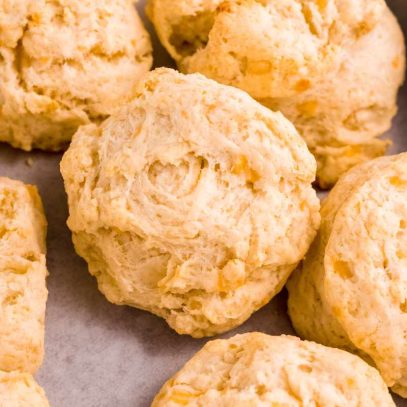 Tight view of tender, fluffy drop biscuits on a serving tray.