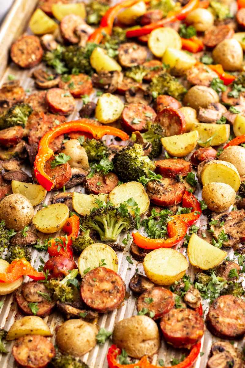 A sheet pan meal of perfectly roasted sausage and veggies ready to serve.