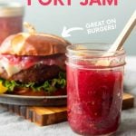 A jar of pink-hued red onion and port jam with a wooden spoon in it stands next to a plate with a cheeseburger topped with onion jam. A text overlay reads, "Red Onion & Port Jam. Great on Burgers! Featuring Half-Pint Jars from the Makers of Ball Home Canning Products."