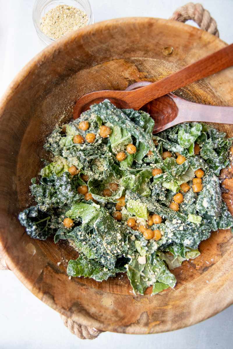 Close view kale caesar salad with crunchy chickpea croutons and hemp seed parmesan.