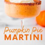Close view of a pumpkin cocktail in a coupe glass rimmed with cinnamon and sugar. A text overlay reads, "Pumpkin Pie Martini."