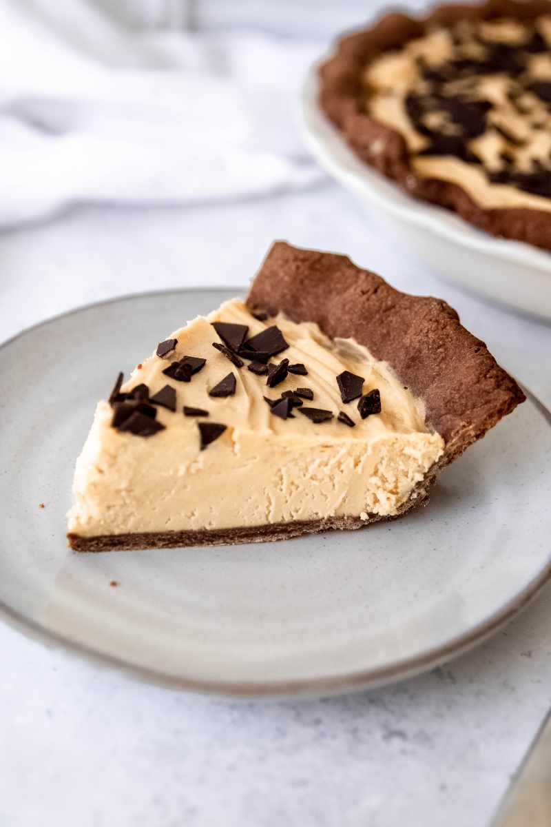 Close view of a slice of chocolate peanut butter pie with fluffy no bake filling.