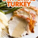 Slices of roasted turkey with gravy with the text overlay "Dry Brine Turkey"