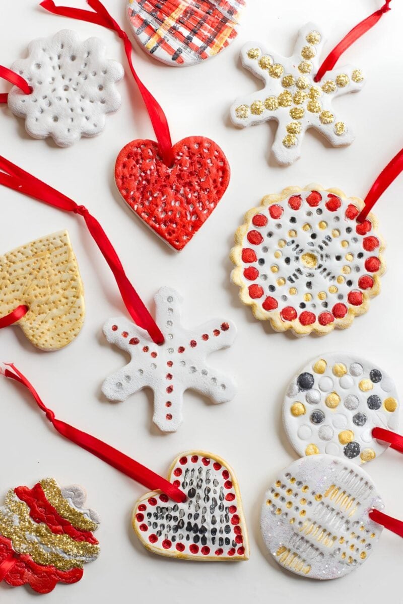Salt Dough Ornaments painted white, red, silver, and gold lay on a white background.