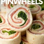 Serving platter of pinwheel appetizers stacked with one on top showing all the spiraled layers inside. A text overlay reads, "Italian Pinwheels."