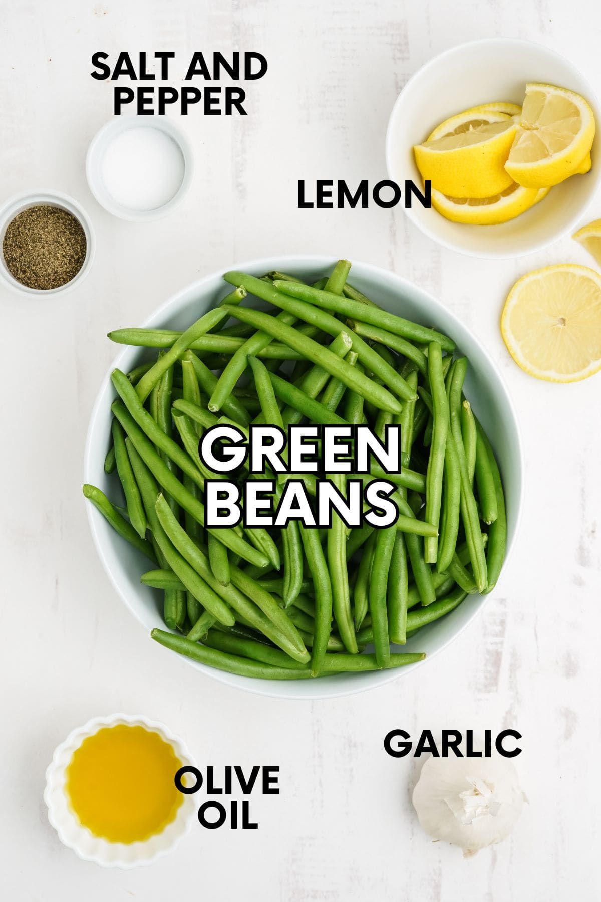 Labeled ingredients for roasted green beans, including green beans, lemon, garlic, olive oil, salt, and pepper