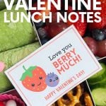 Close view of an adorable note that says, "Love you Berry Much!" on top of a school lunch. A text overlay reads, "Free Printable Valentine Lunch Notes."