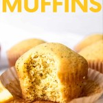A lemon poppyseed muffin with a bite taken out, showing the speckled inside, sits in its peeled liner. A text overlay reads, "Lemon Poppyseed Muffins."
