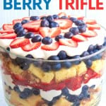 A berry trifle served in a glass trifle dish showing the layers of cake, berries, and cream. A text overlay reads, "Red, White, & Blue Berry Trifle."