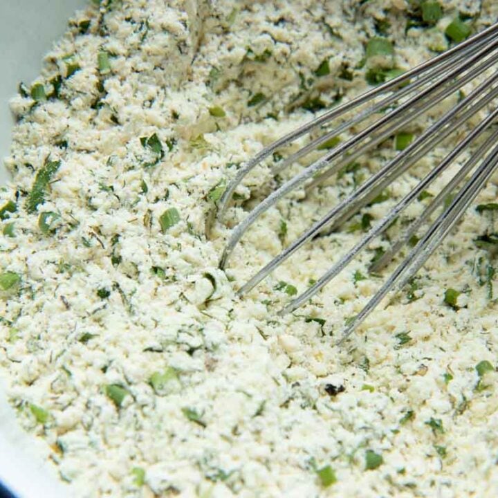 Close view of ranch dressing mix in a bowl with a metal whisk.