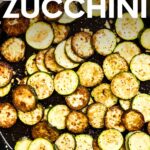 Top view of sauteed zucchini and garlic in an enameled cast iron skillet. A text overlay reads, "Sauteed Zucchini."