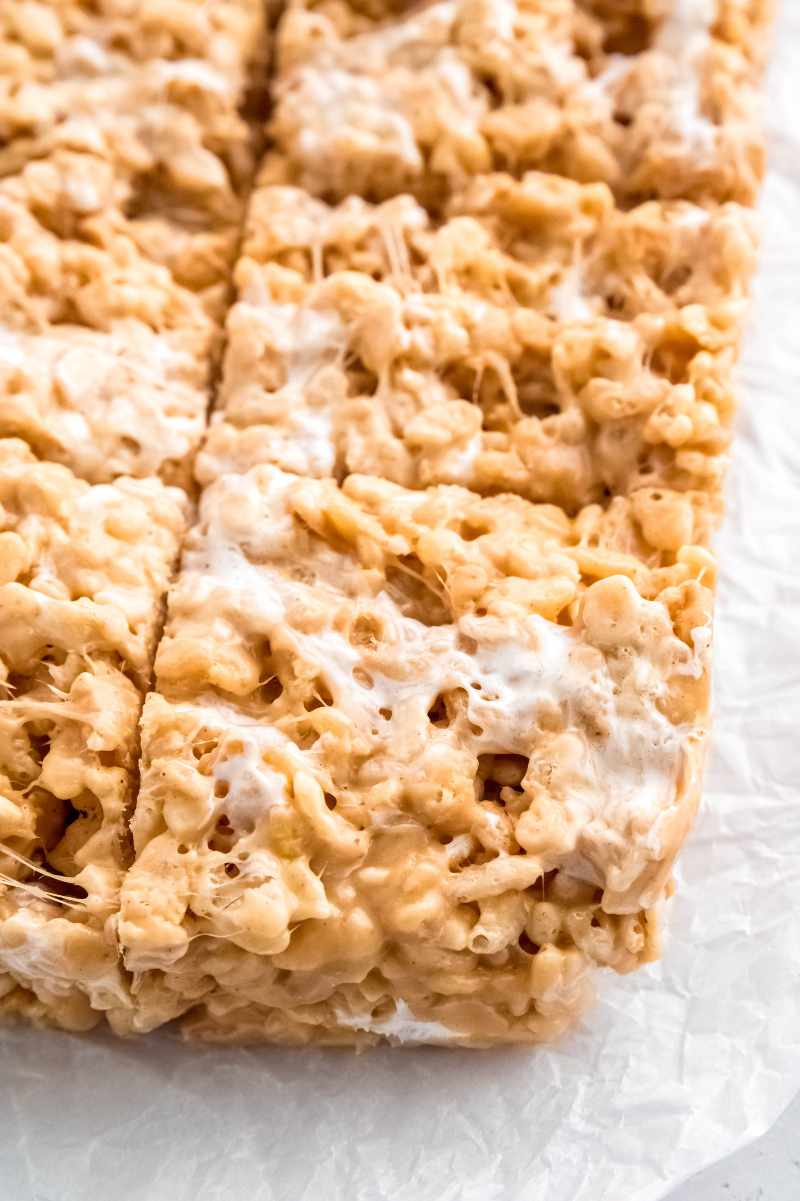 Close view of peanut butter rice krispie treats cut into squares.