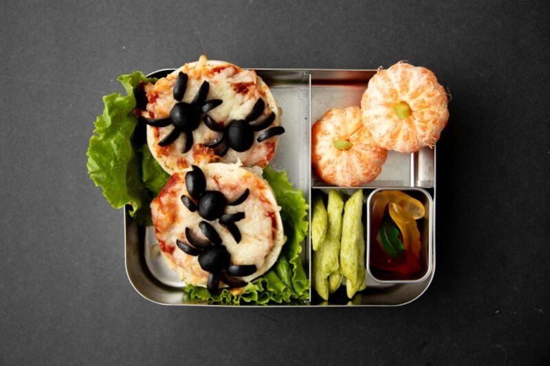 Halloween lunch idea: Easy english muffin pizza lunch with clementines, snap pea snack crisps, and gummy worms.
