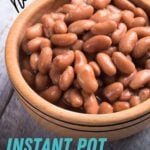 Close view of perfectly cooked beans in a wooden bowl on a light background. A text overlay reads, "No Soak! Instant Pot Pinto Beans."