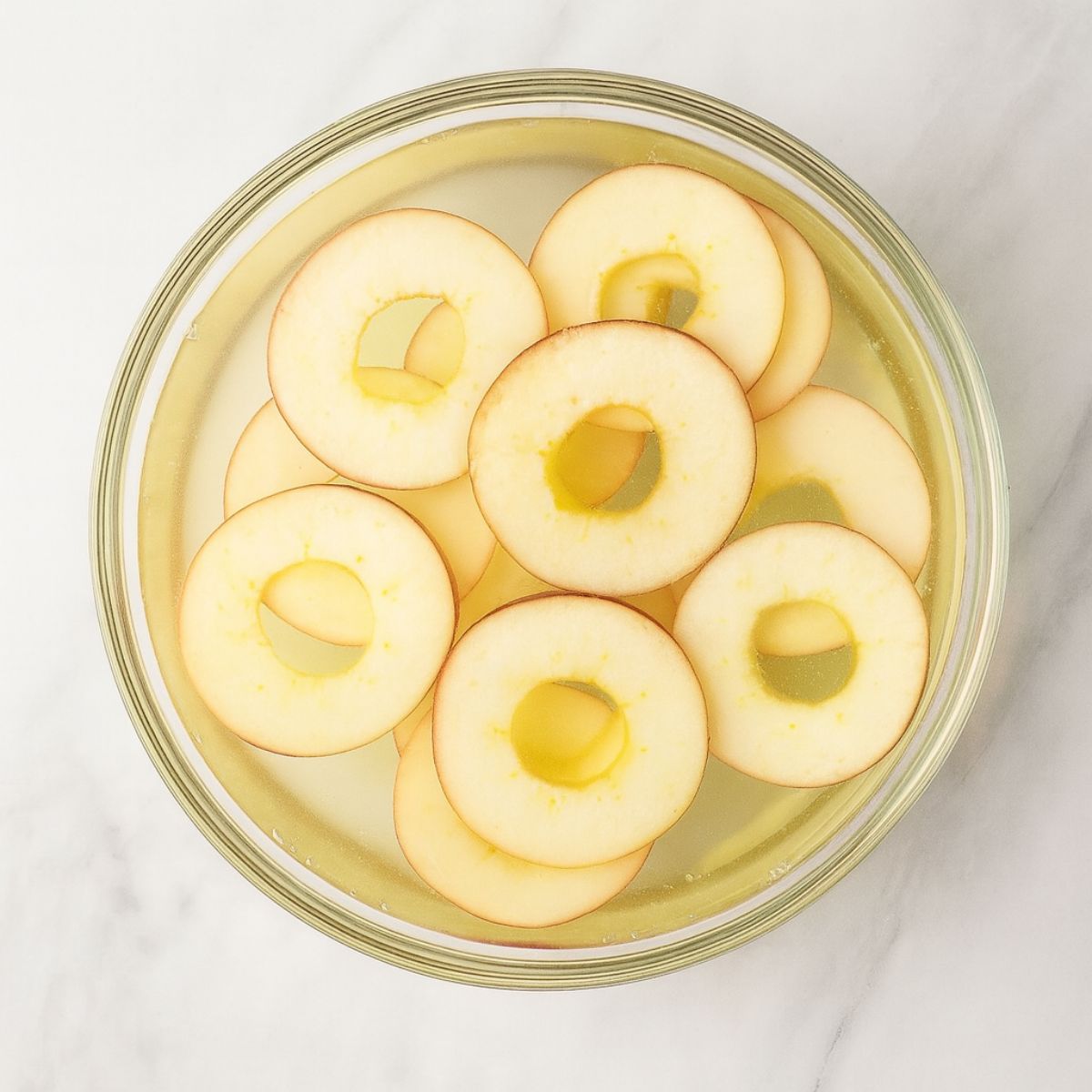 Treating apple slices in lemon juice to prevent browning