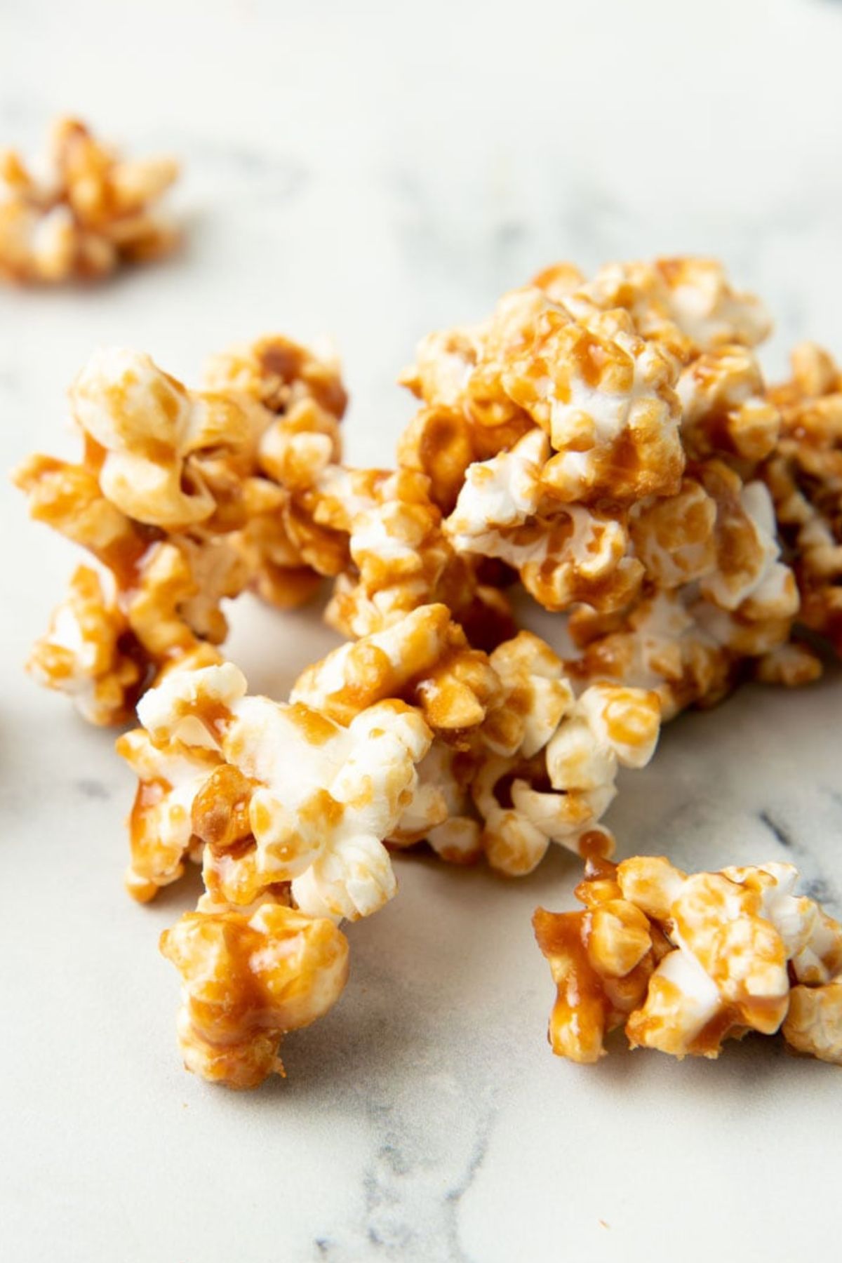 Pile of caramel corn on a white marble countertop