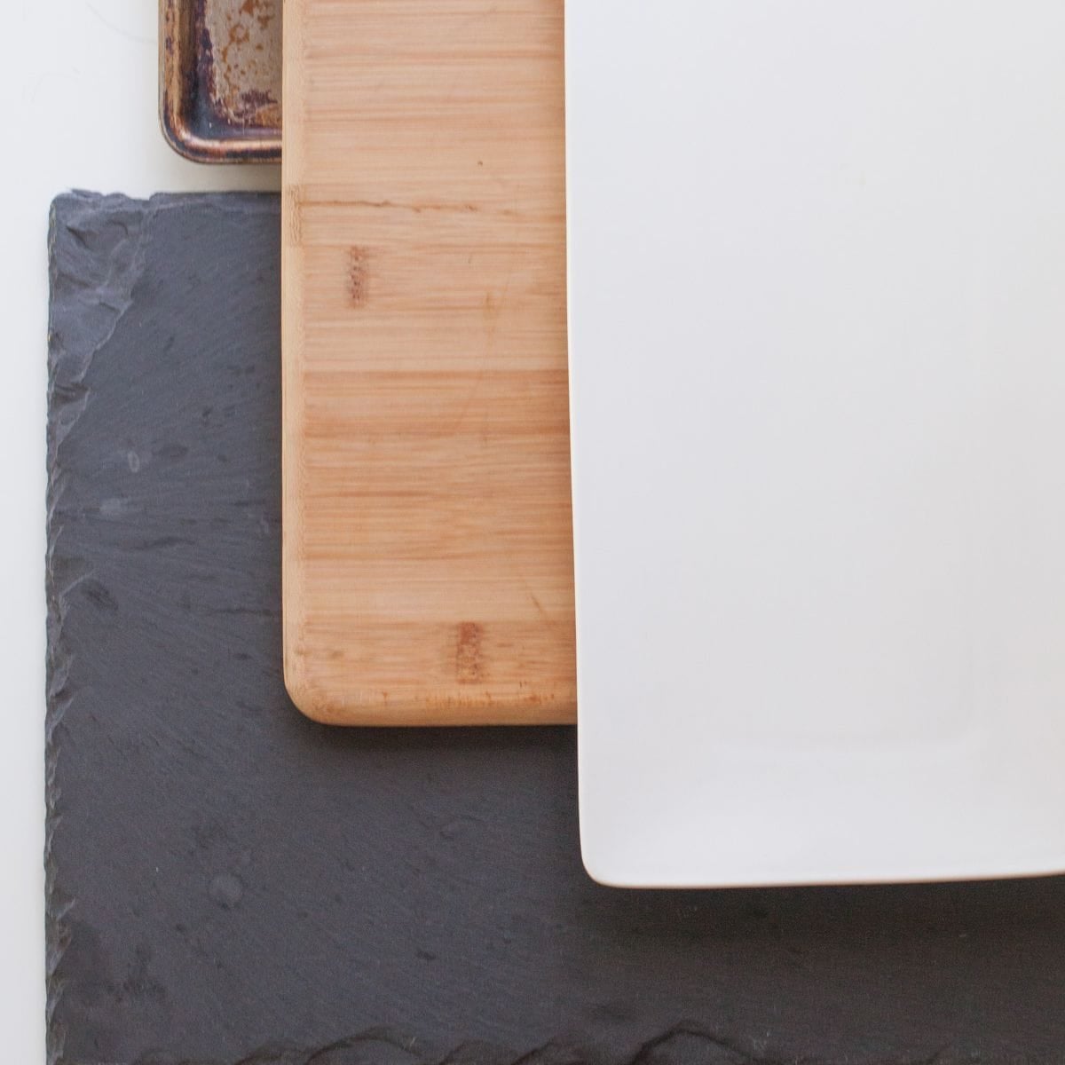 Various cheese boards stacked on a counter