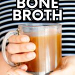 Hand holds a mug of bone broth