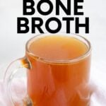 A mug of bone broth on a white countertop