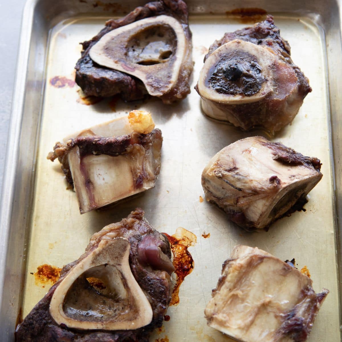 Roasted beef bones on a baking sheet