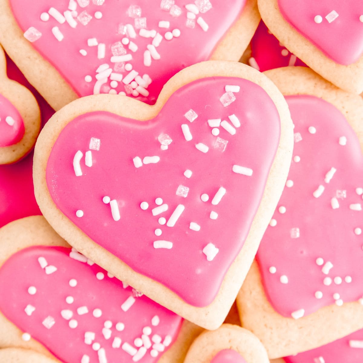 Pink heart Valentine's Day sugar cookies stacked on top of each other