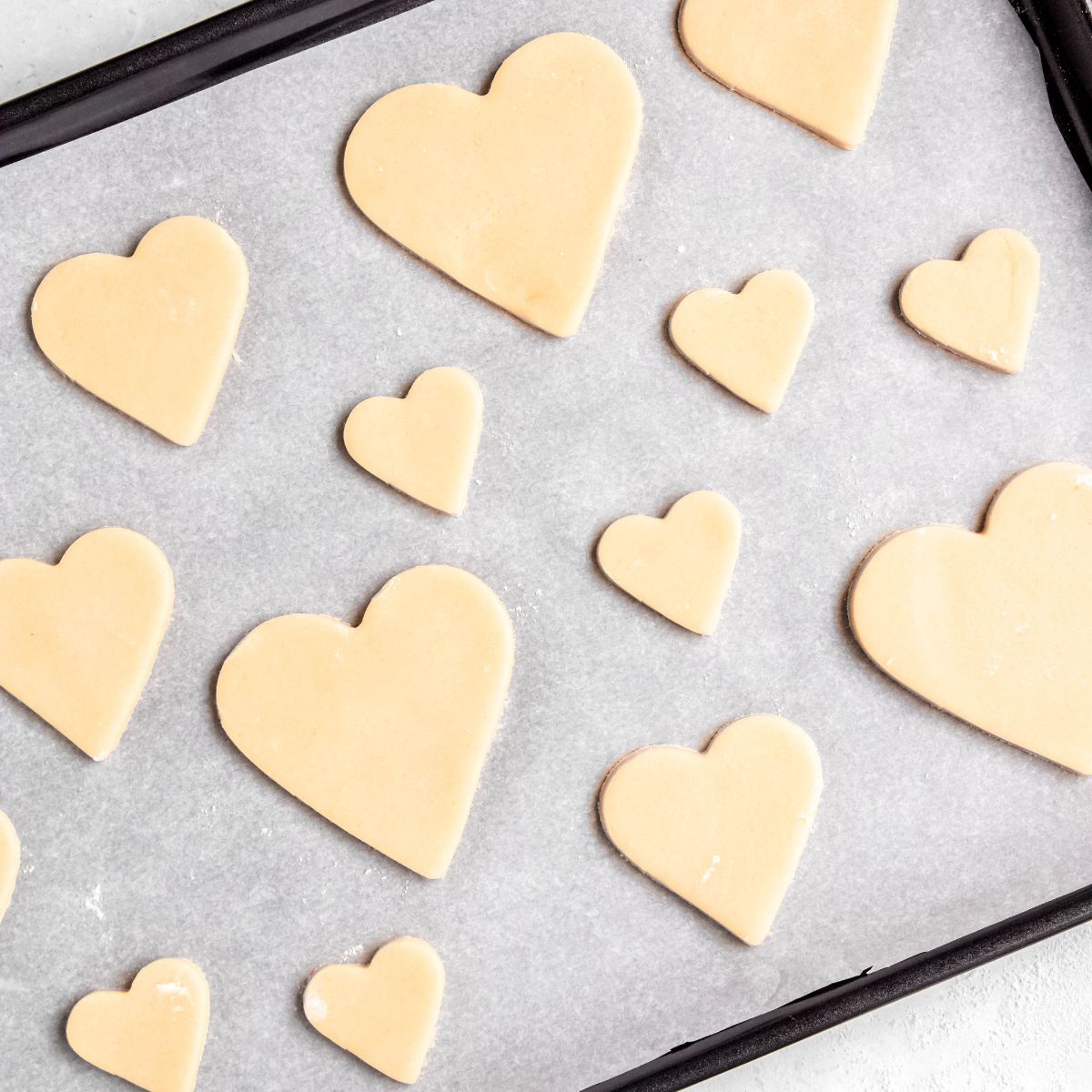 Unbaked heart sugar cookies on tray