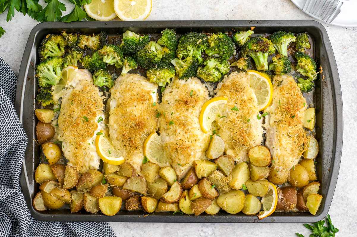 Overhead of a sheet pan chicken dinner with broccoli and potatoes.