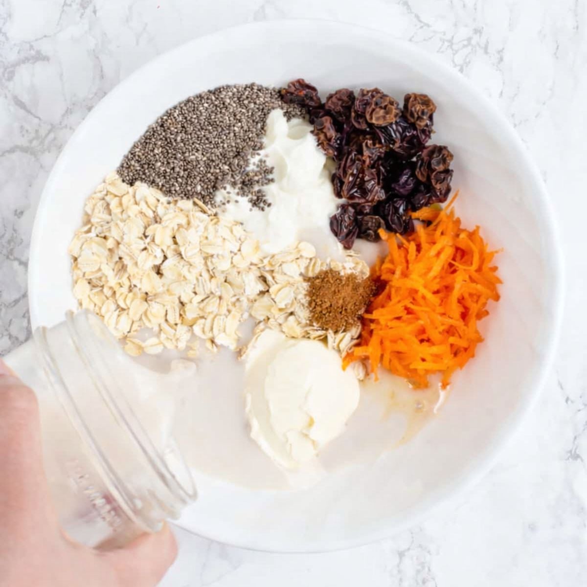Carrot cake overnight oats ingredients in mixing bowl