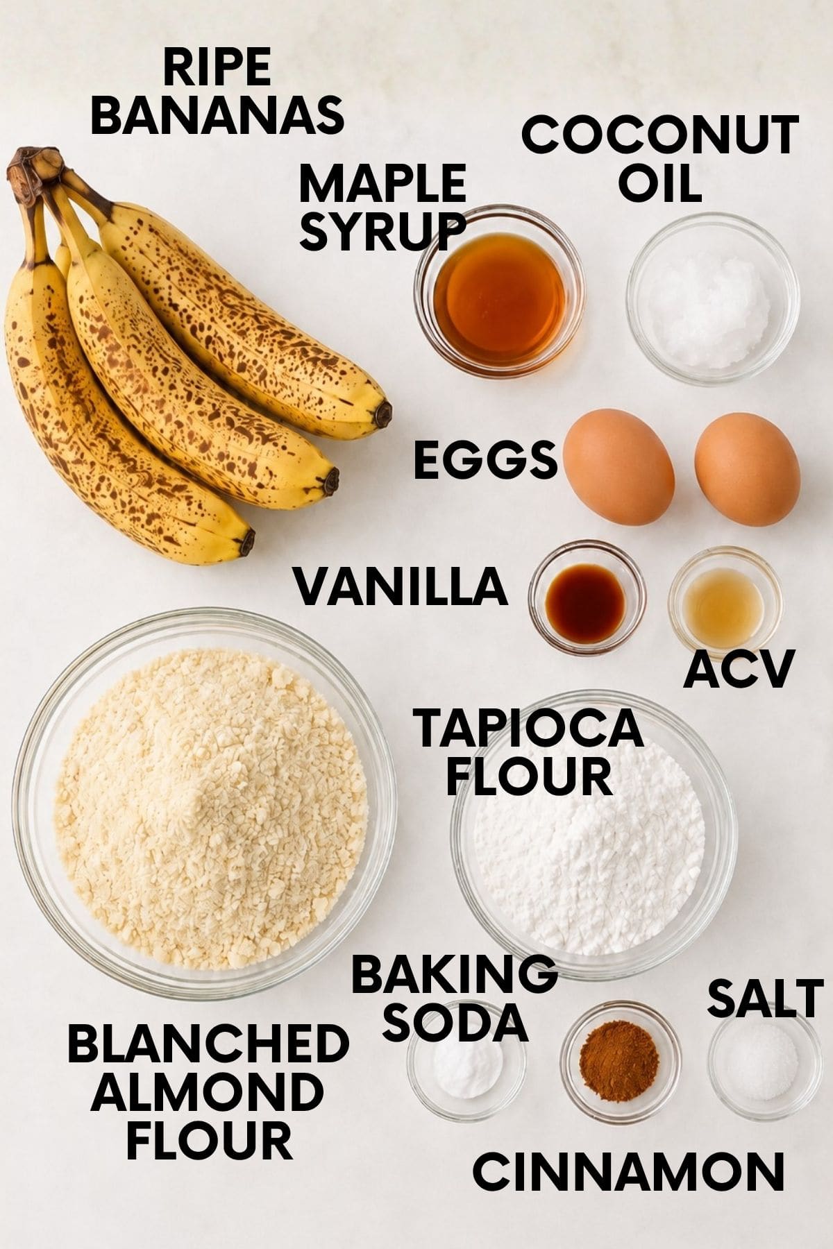 Ripe bananas, maple syrup, coconut oil, eggs, vanilla, apple cider vinegar, tapioca flour, blanched almond flour, baking soda, cinnamon, and salt, each labeled for making almond flour banana bread.