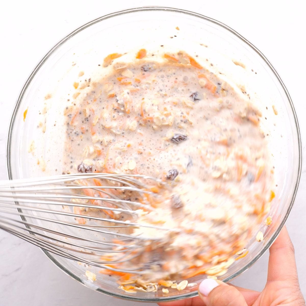 Mixing carrot cake overnight oats with whisk