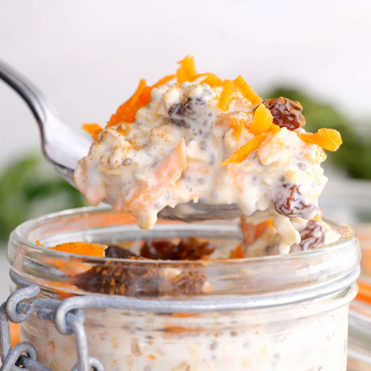 Scooping spoonful of carrot cake overnight oats