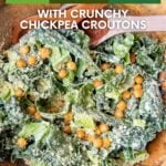 Kale caesar salad with crunchy chickpea croutons in a wood bowl, labeled with the recipe title.