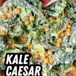 Kale caesar salad recipe title over a bowl of the tossed salad with chickpeas and parmesan.