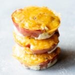 Close view of three ham and egg cups stacked on a light background.