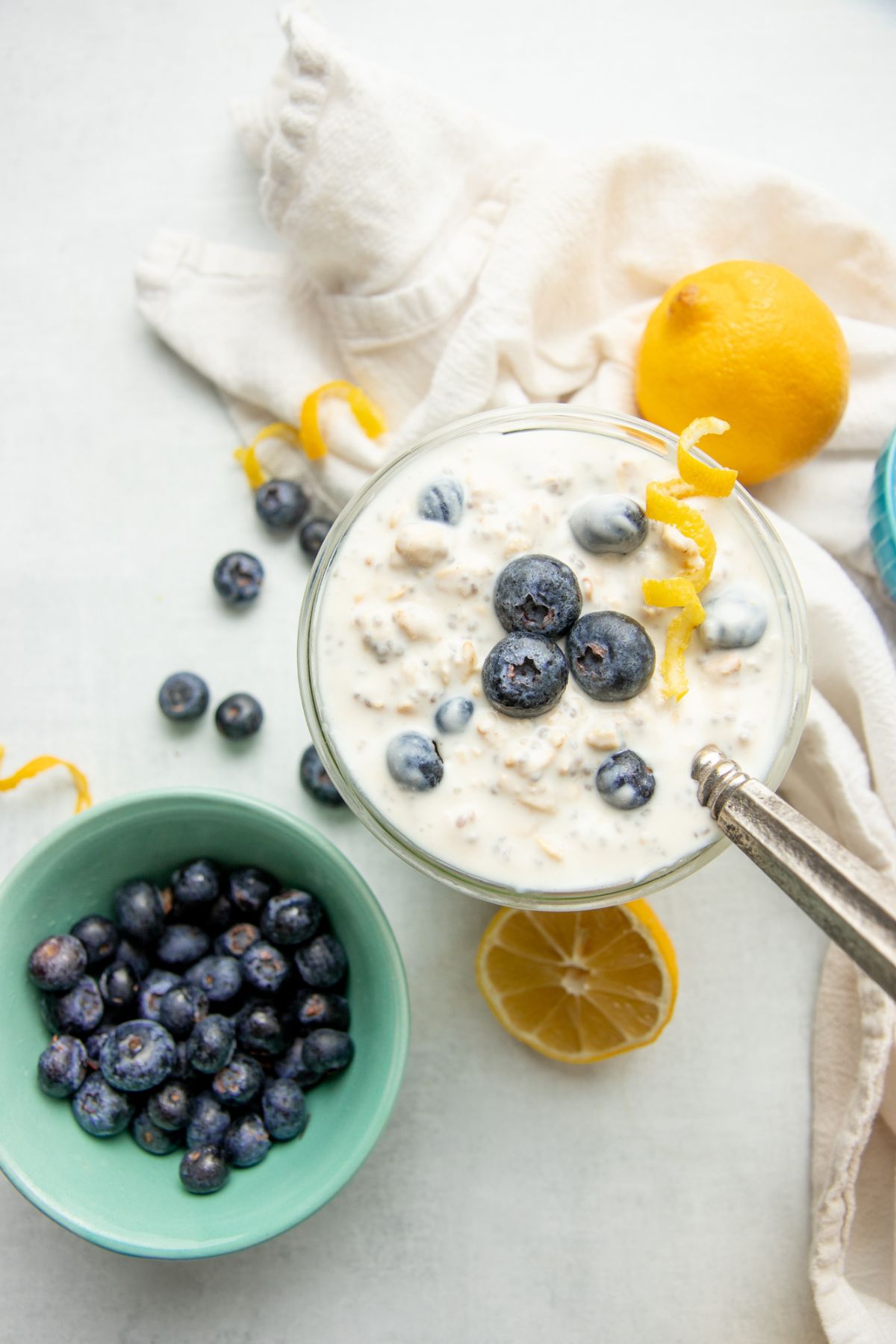 Spoon scooping blueberry overnight oats out of a jar