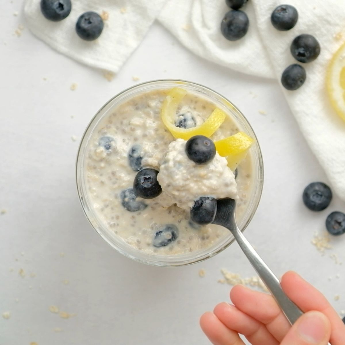 Scooping a spoonful of overnight oats out of the jar