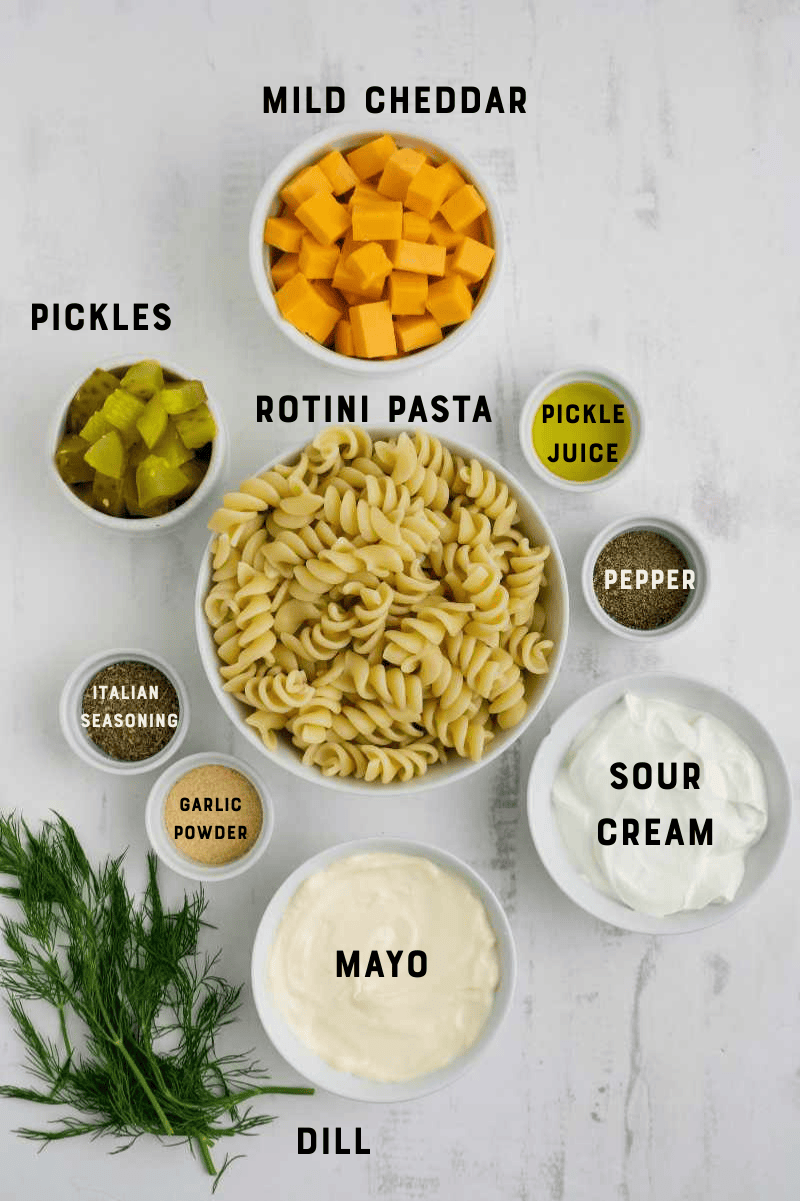 Ingredients for pickle pasta salad, with each ingredient labeled.