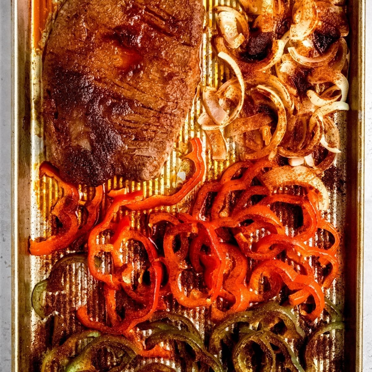 Roasted steak and peppers on a sheet pan